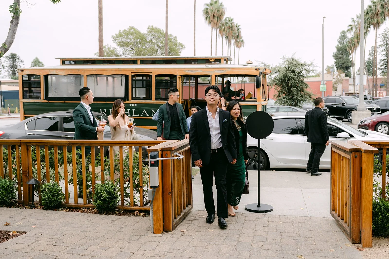 Guests arriving at The Richland's front patio with a vintage trolley parked behind.