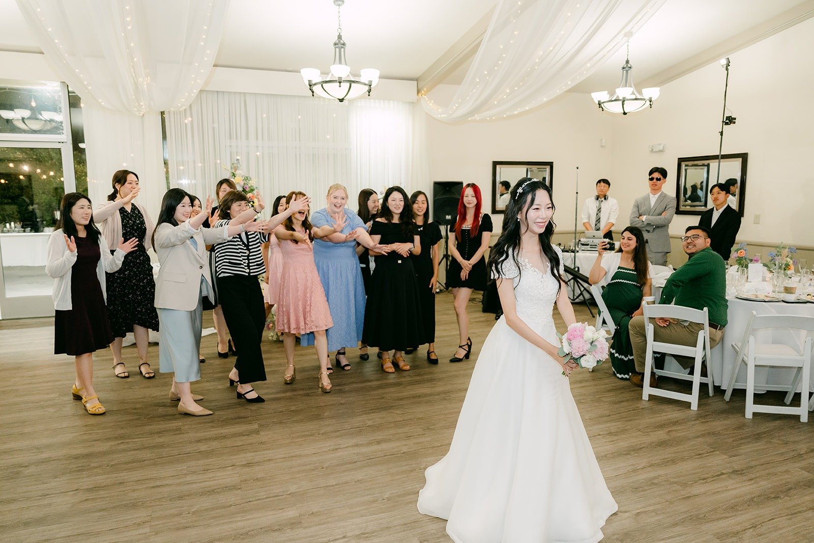 Guests waiting on the dance floor for the bouquet toss