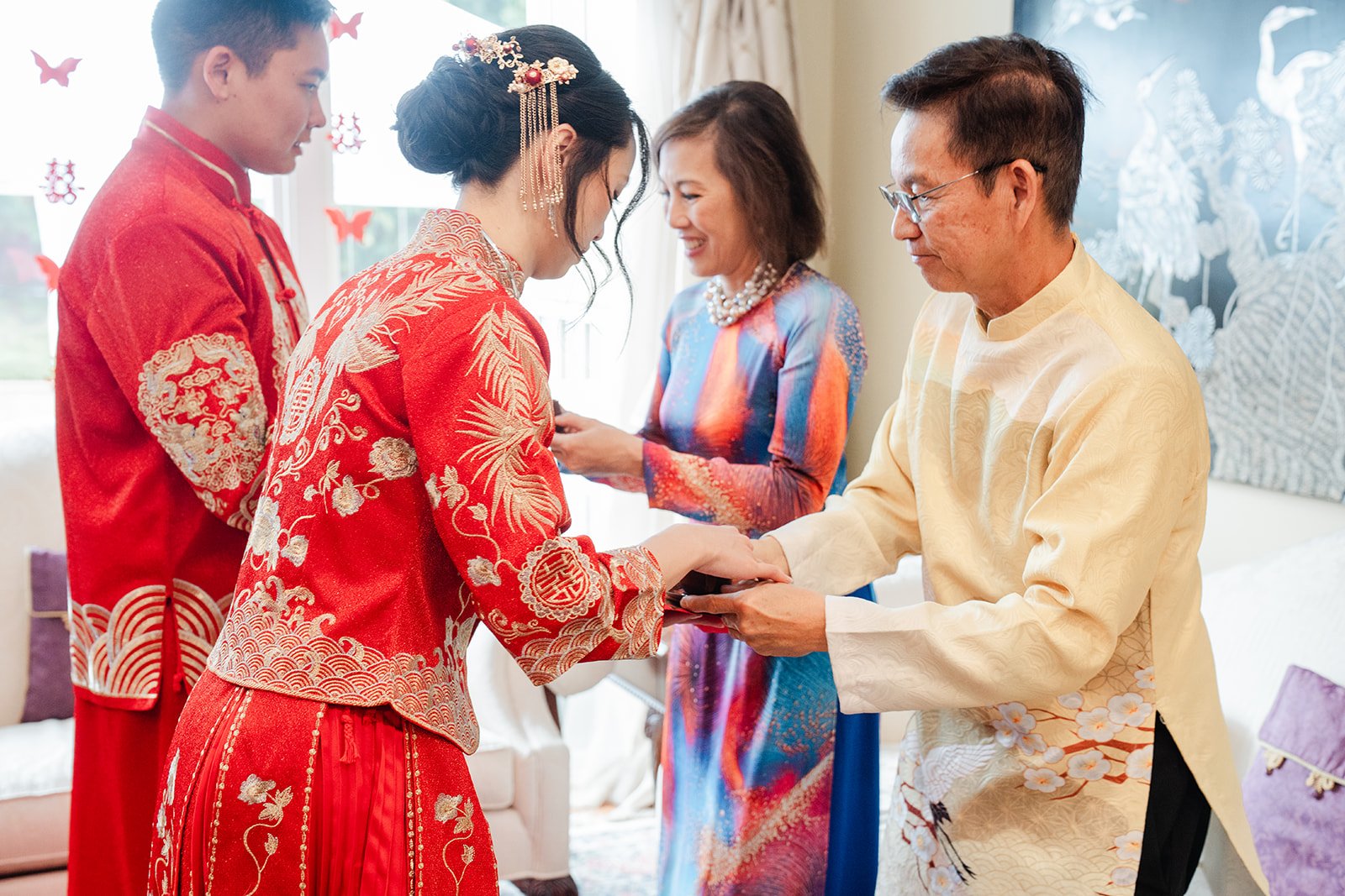 Family gathered around the couple as gifts are given.