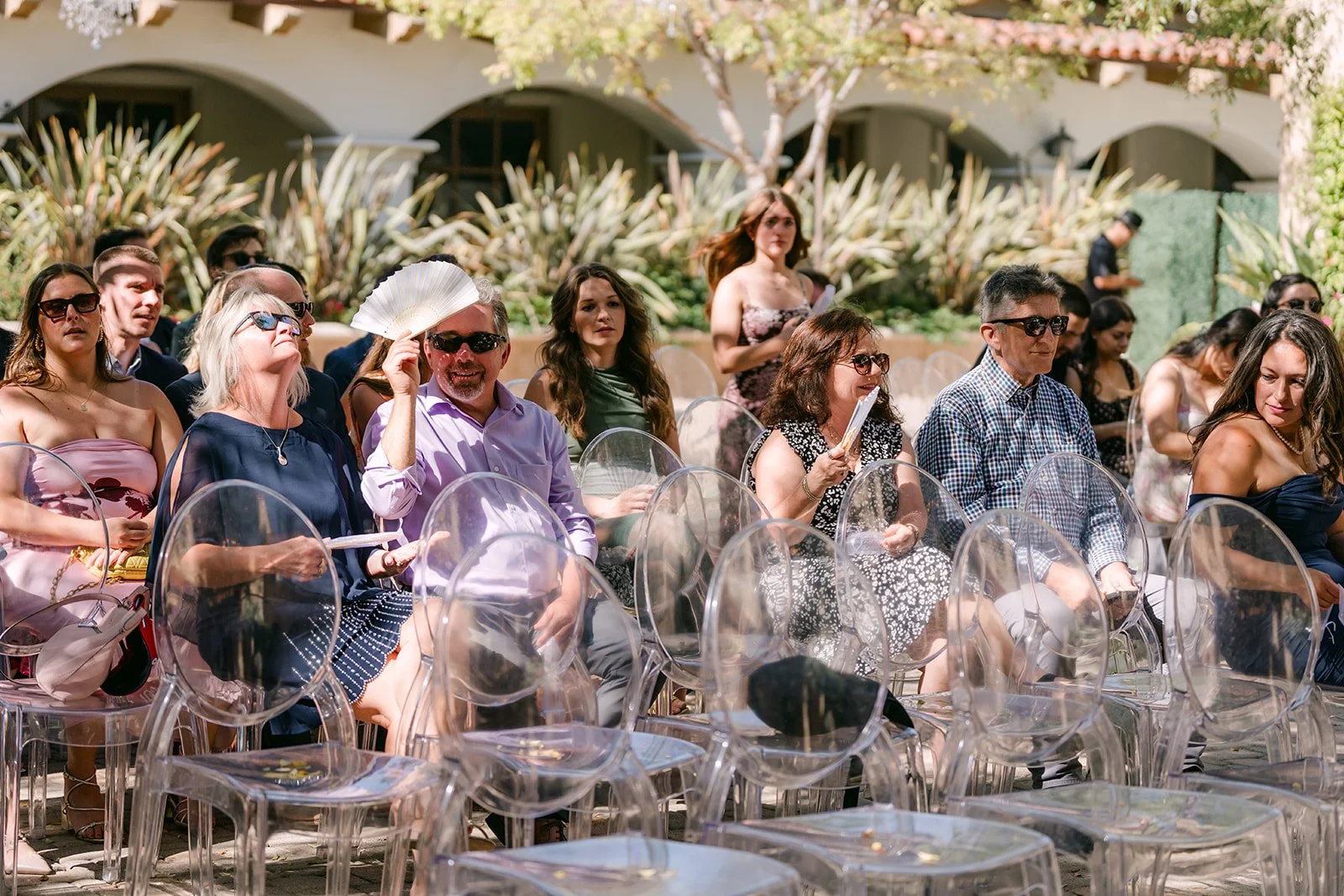 Crowd of guests smiling in the ghost chairs