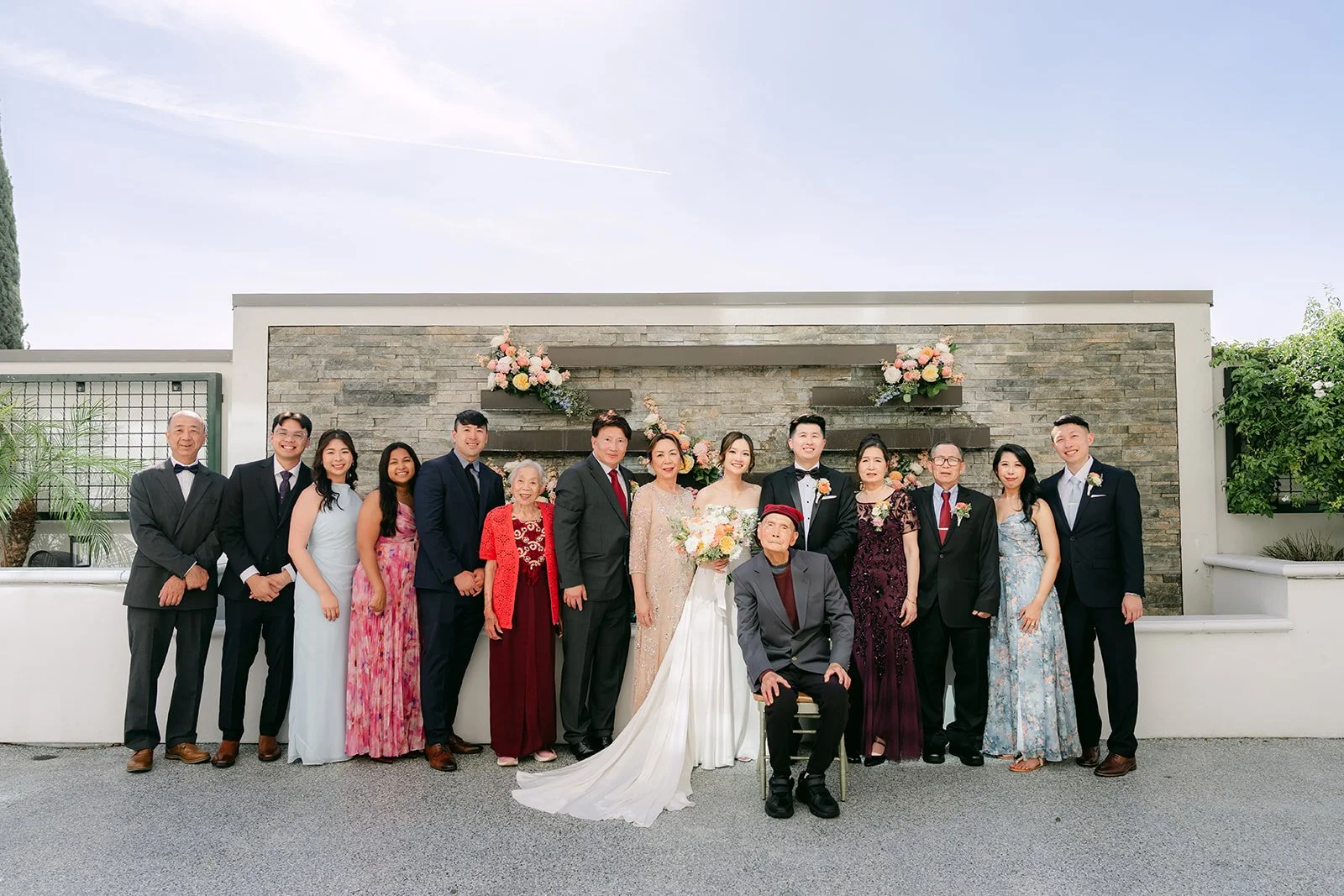 A large family group photo with Amanda and San on the terrace.