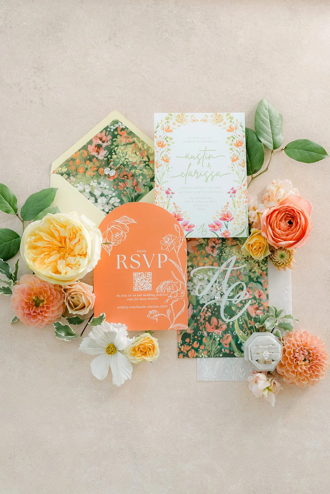 Clarissa and Austin's watercolor invitation suite with an orange RSVP card and pastel flowers
