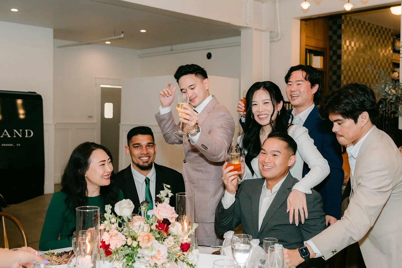Friends raising their glasses with Denise and Michael.