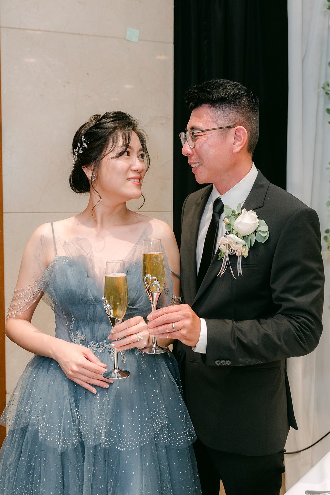 Eunice and Eric raise a toast beside the cake
