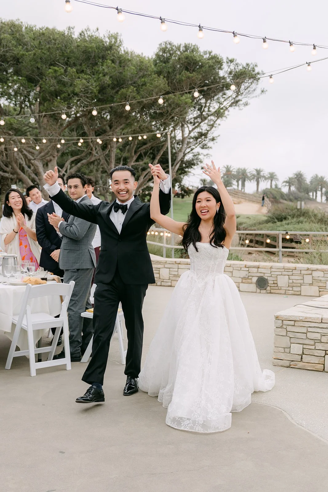 Kim and Vincent cheering as they are introduced as Mr. and Mrs.