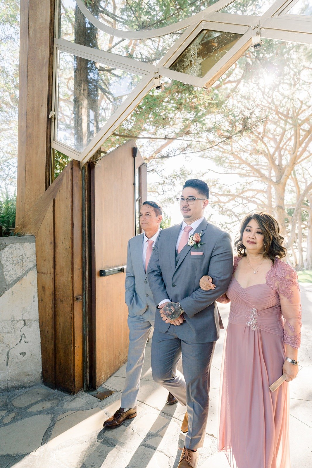Mikey walks into Wayfarers Chapel with a family member