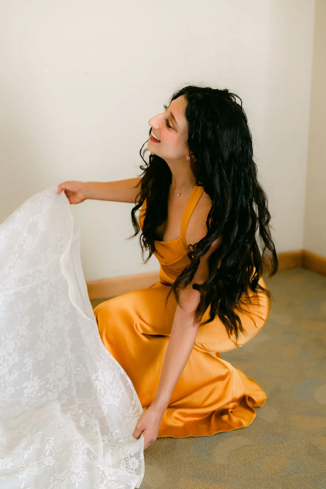 A bridesmaid arranging Kim's train