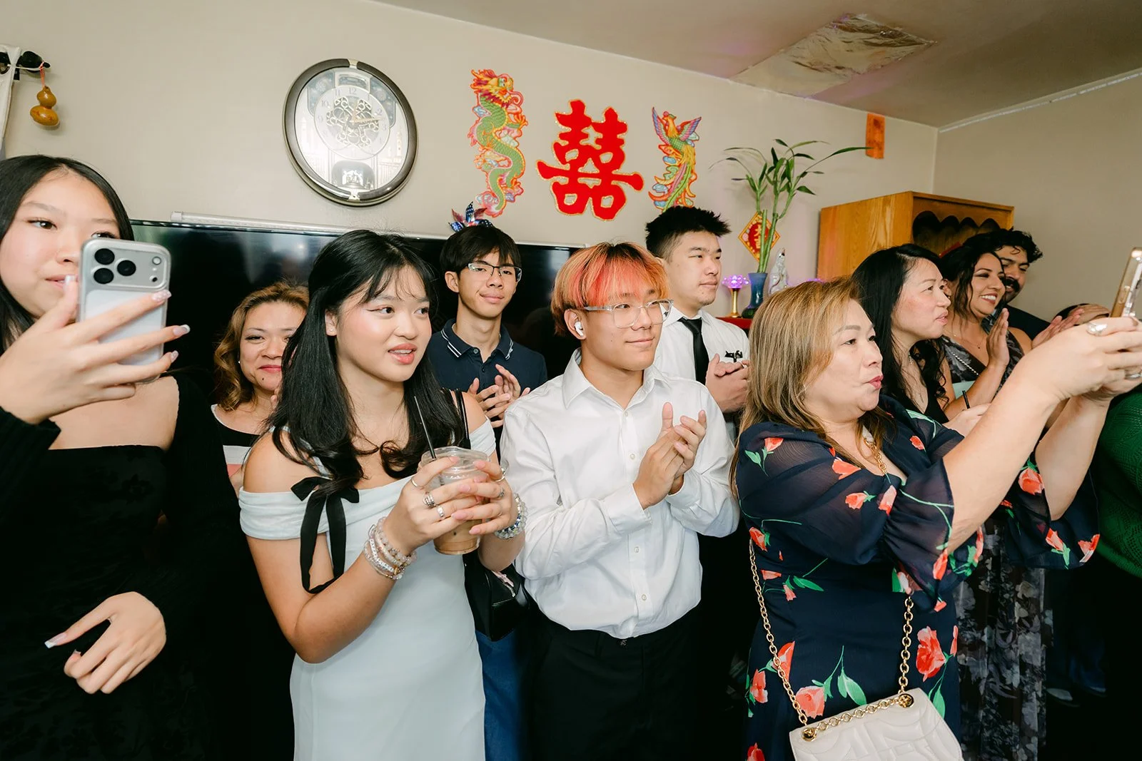 Family cheering and filming as Ryan comes inside.