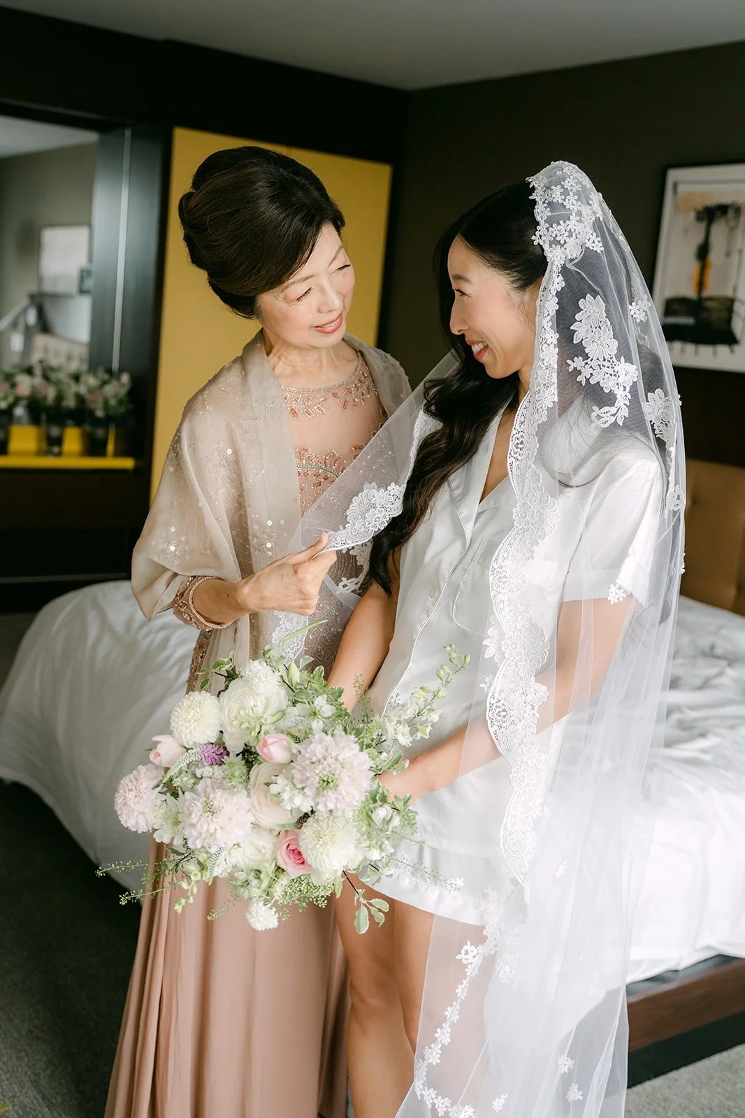 A loved one helping Kristine with her lace edged veil