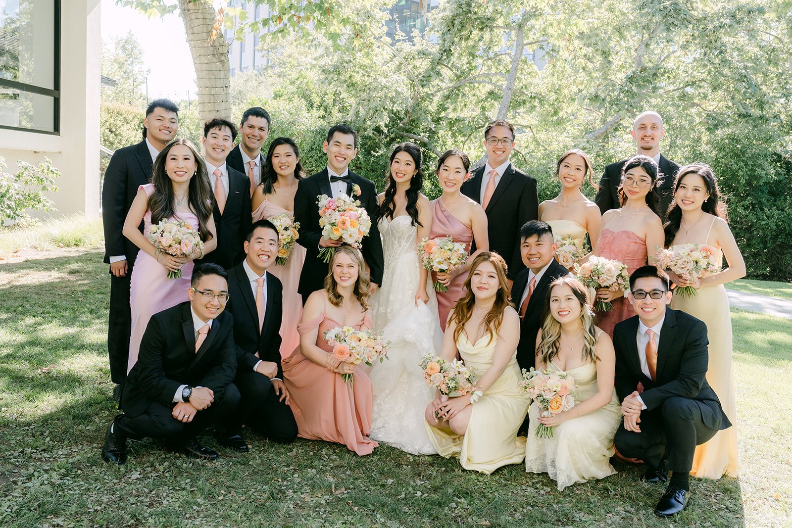 The wedding party cheering on the lawn