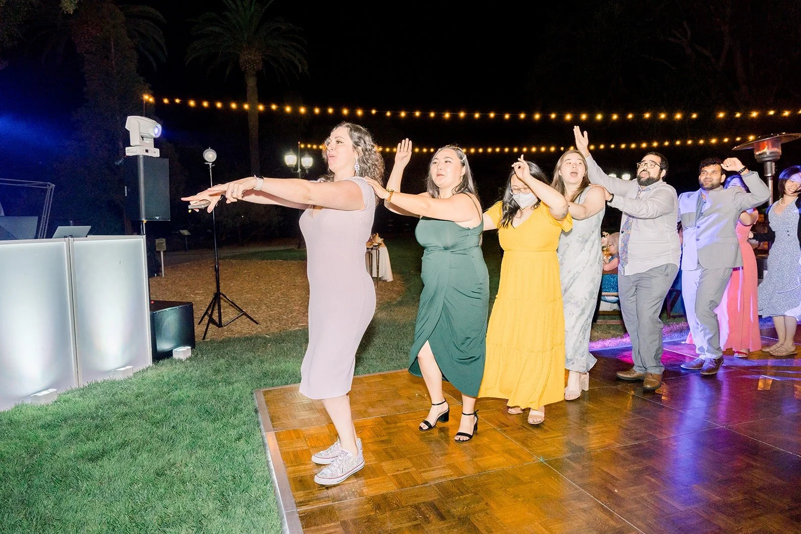 Guests dancing in a line on the dance floor