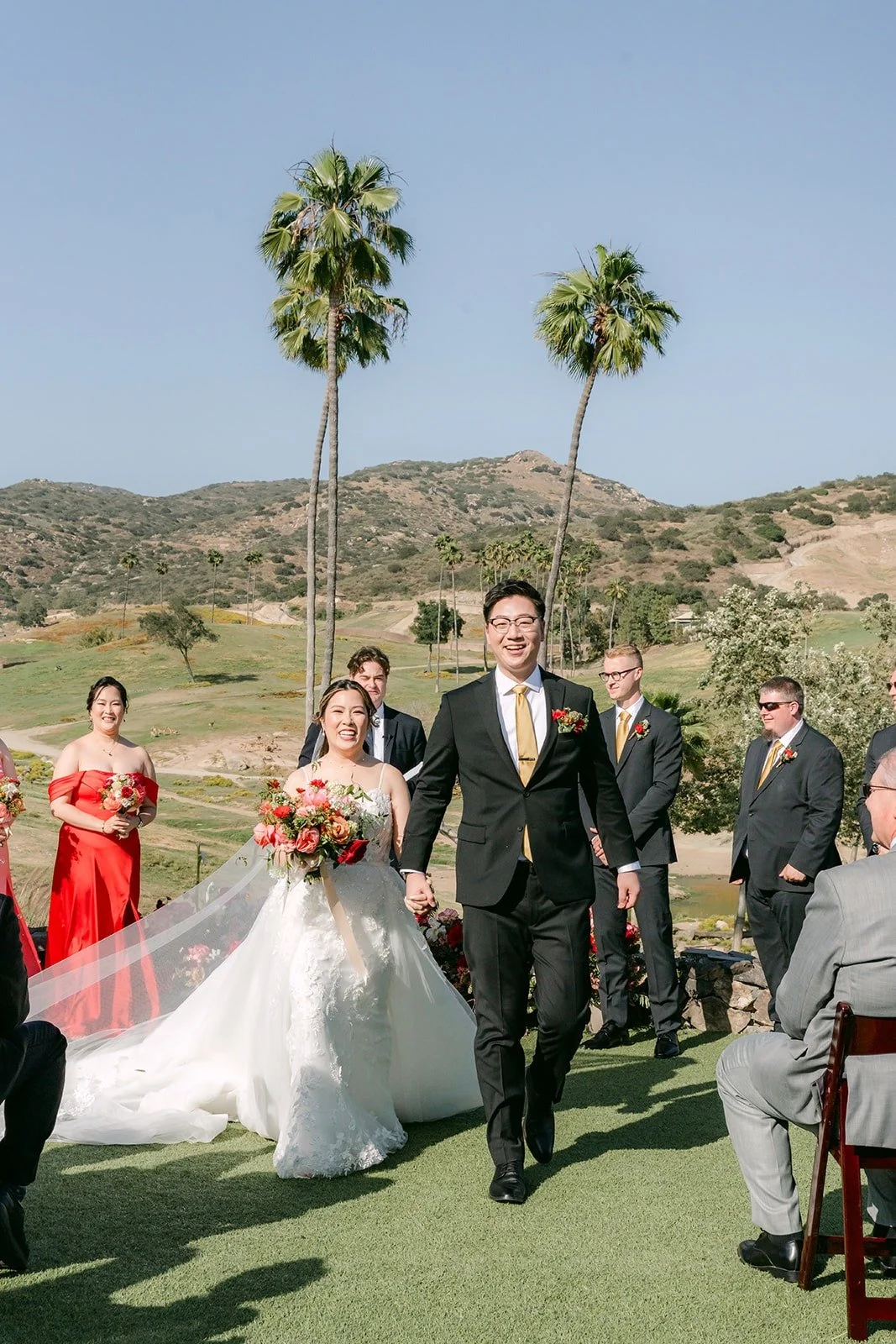Joanne and Zach walking back up the aisle as husband and wife