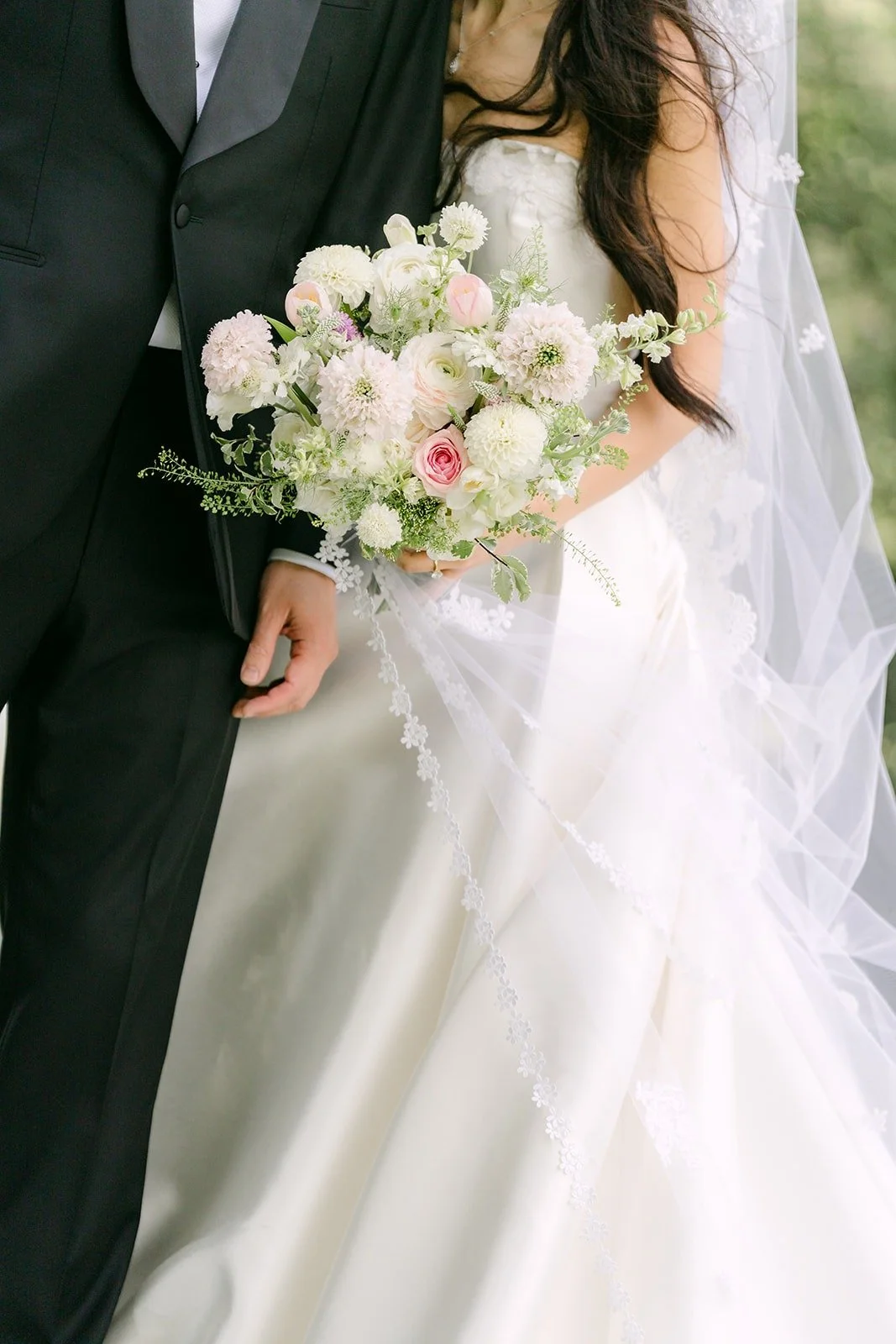 Close up of Kristine's bouquet against William's tuxedo
