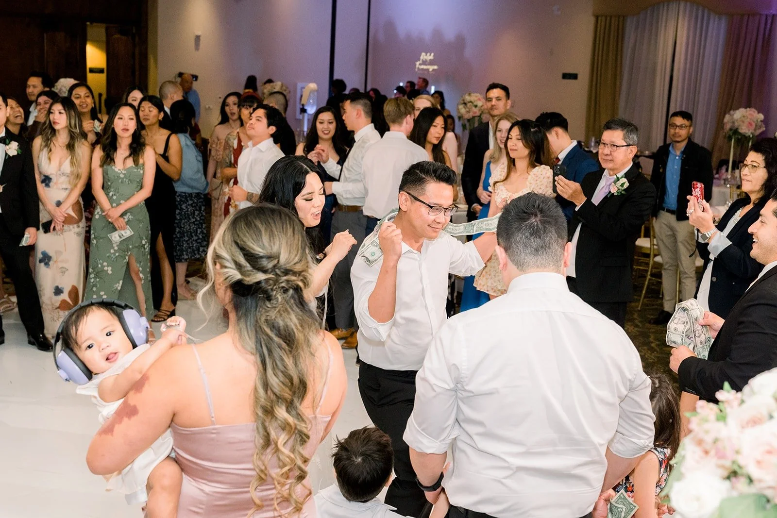 Guests crowding the dance floor for the money dance