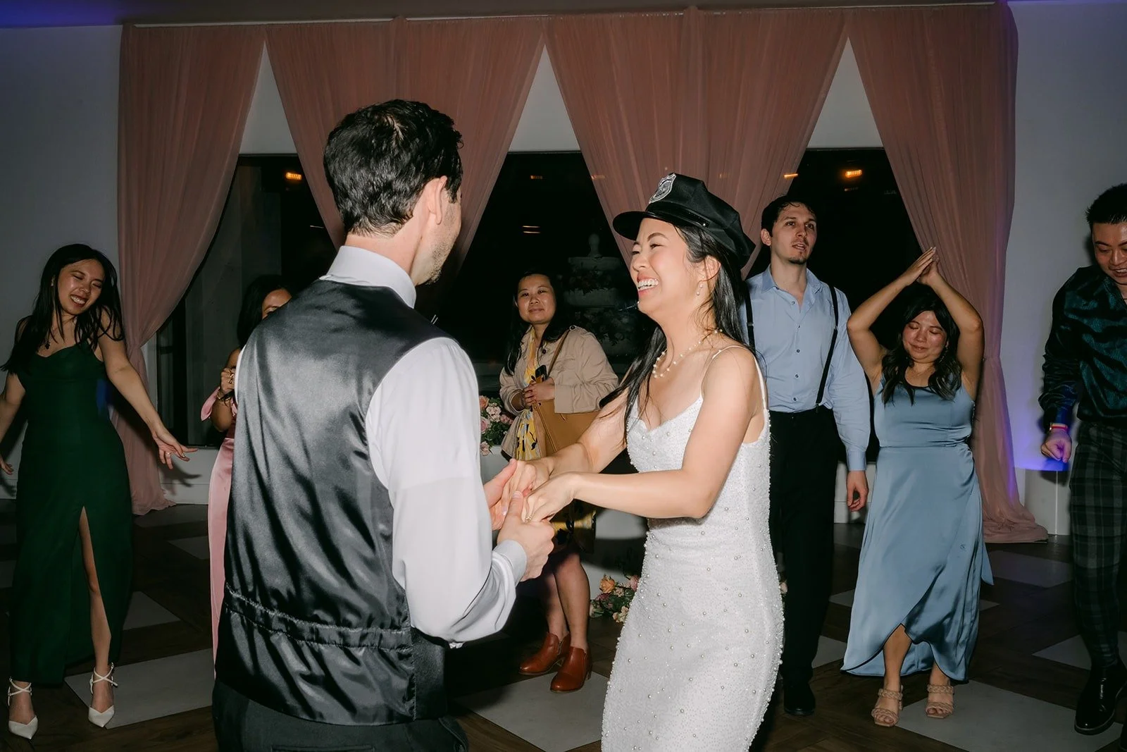 Stephanie in a black hat dancing with Kevin