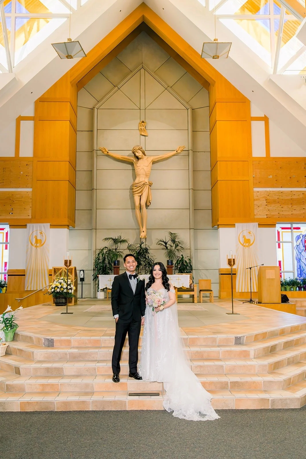 Francesca and Ralph standing before the altar beneath the church's wooden ceiling