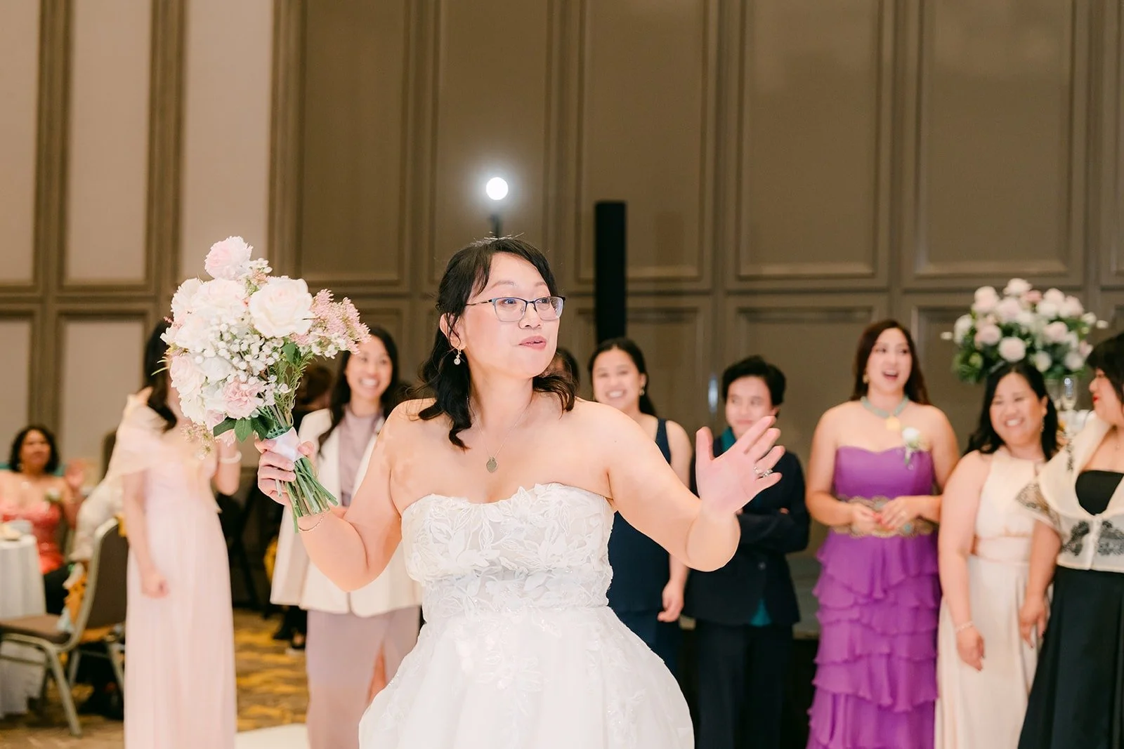 Stella tossing her bouquet over her shoulder