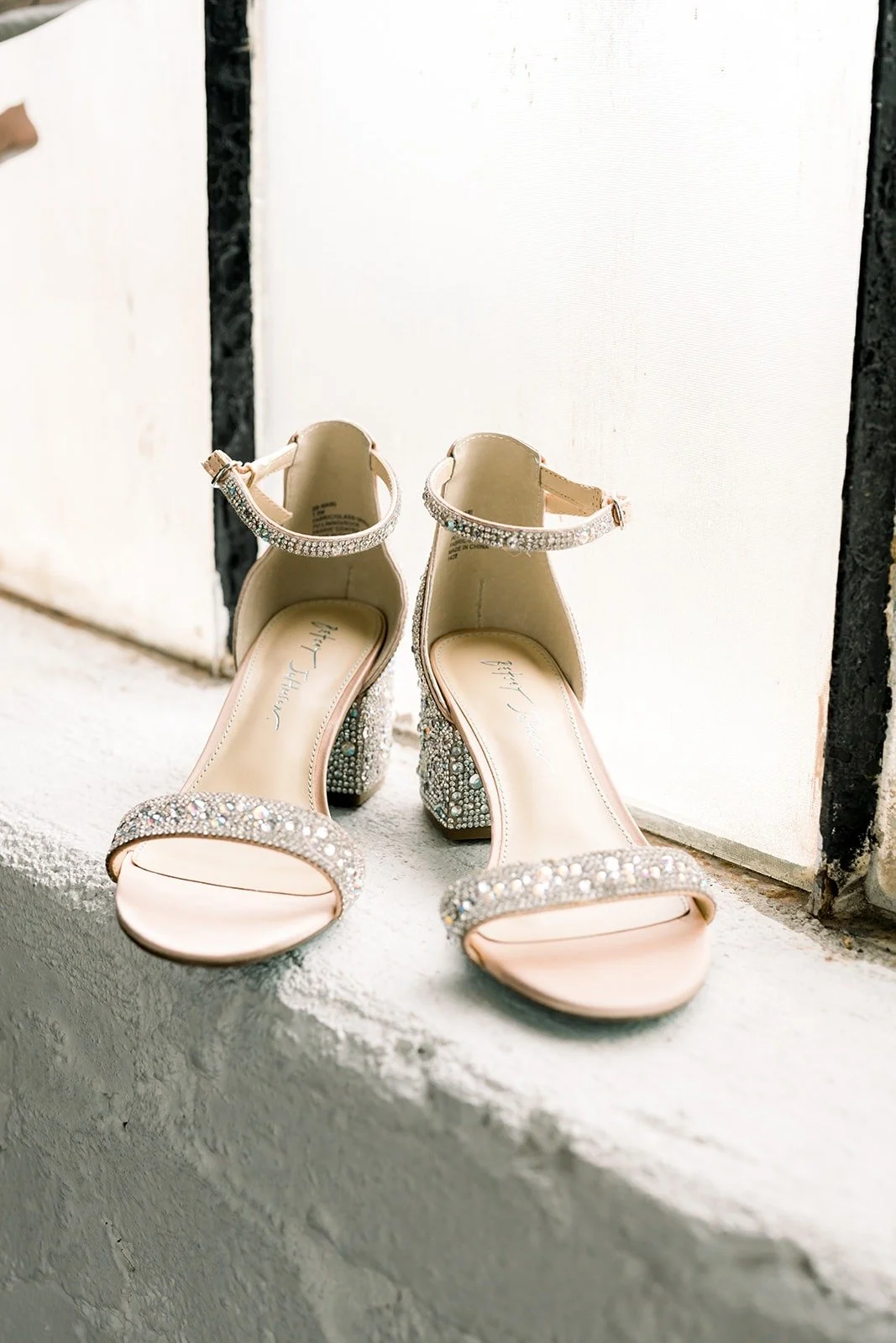 Cindy's sparkly strappy heels on a windowsill at The East Angel, photographed by One and Only Production