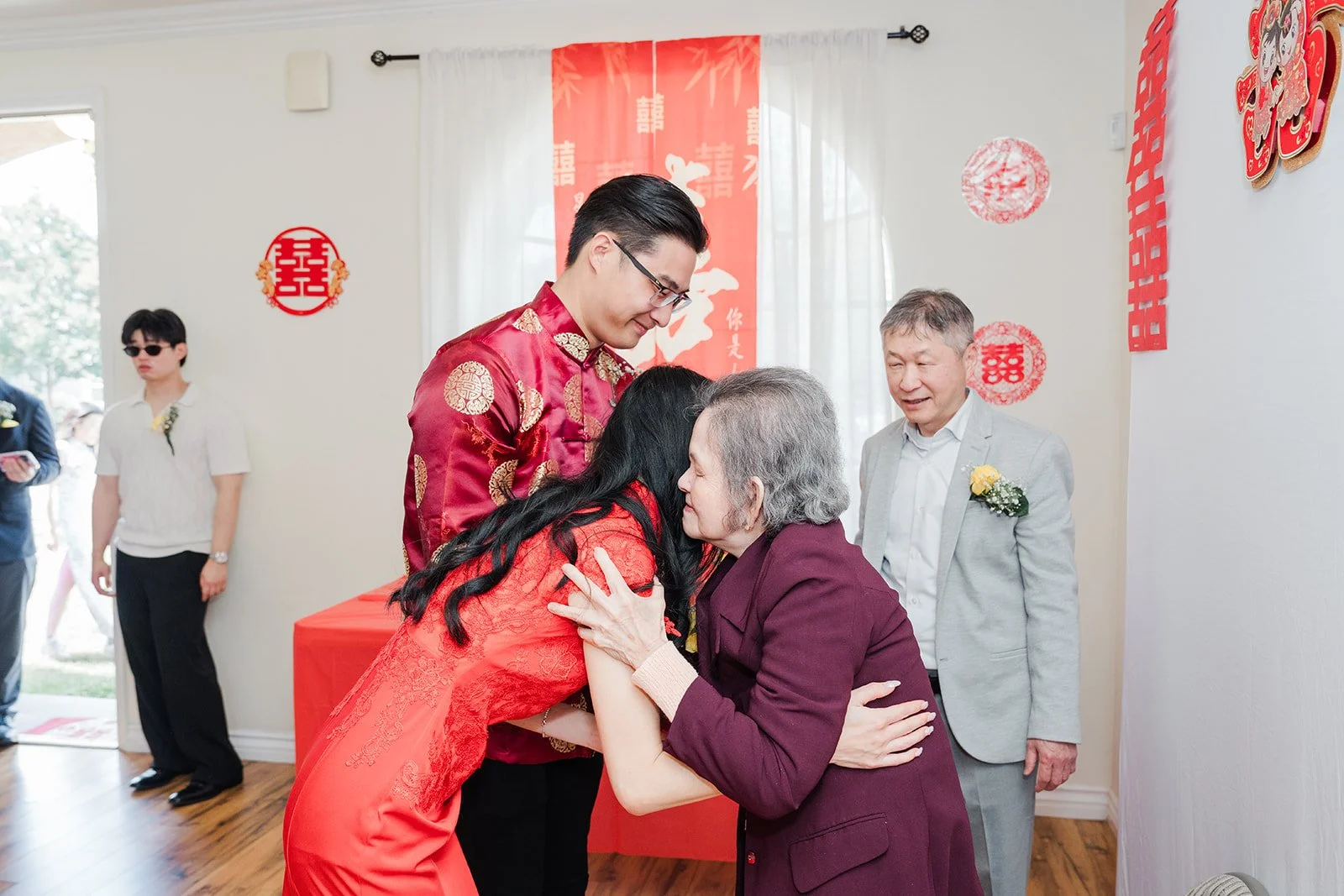 Valerie and Danny offering tea to an elder.