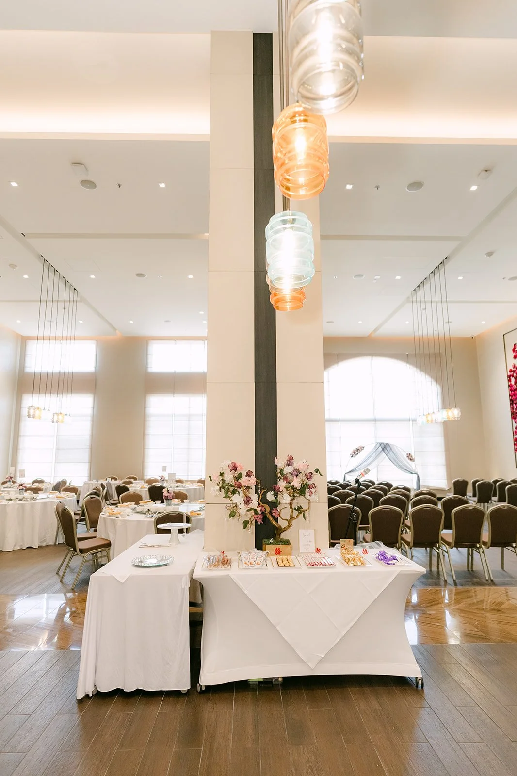 Reception room at the Sheraton with round tables and pendant lights.