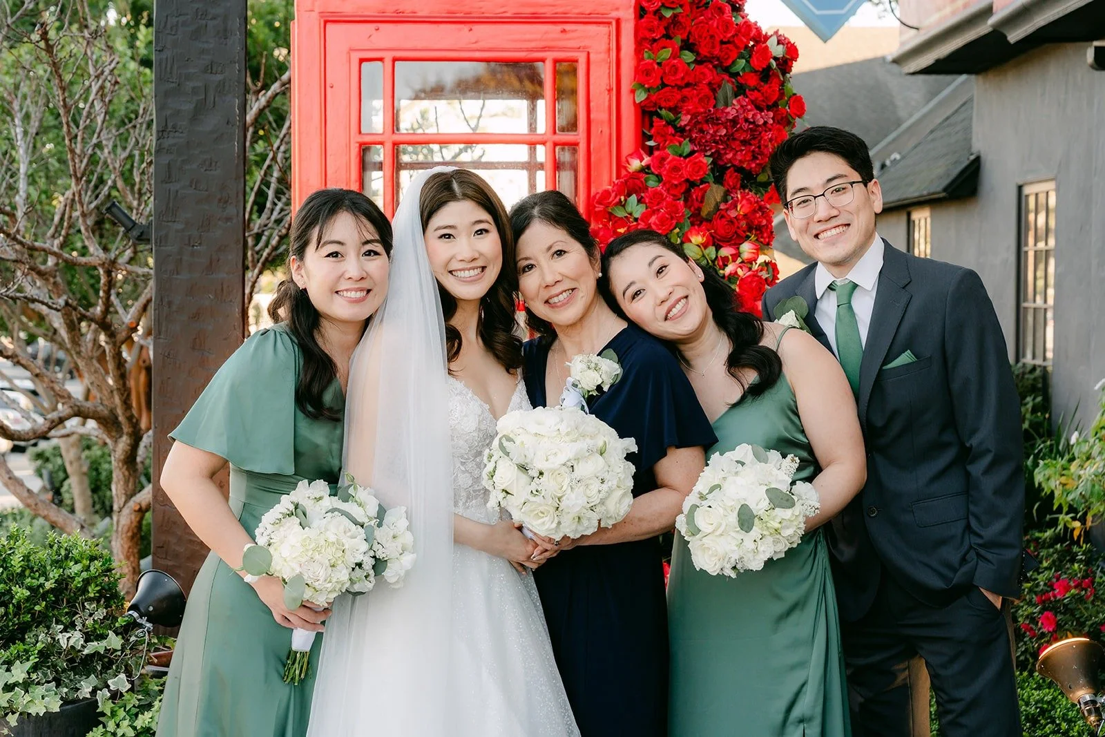 Valerie and Jason with friends beside the red roses