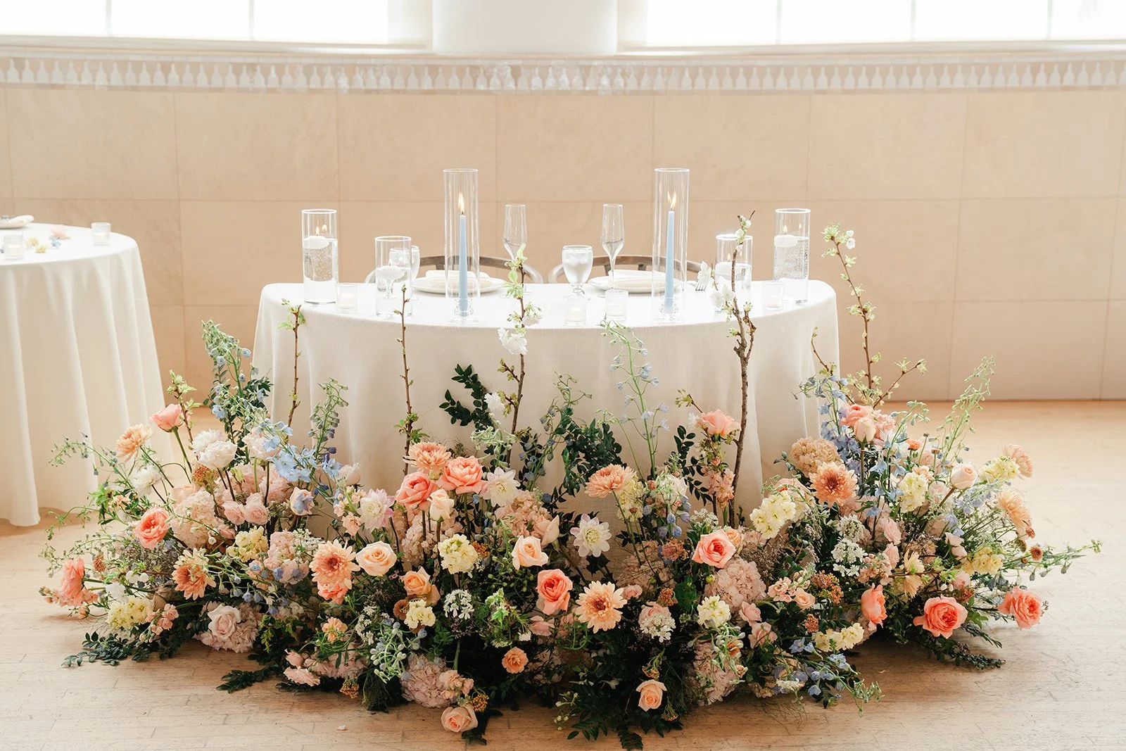 Sweetheart table surrounded by a ring of pastel florals