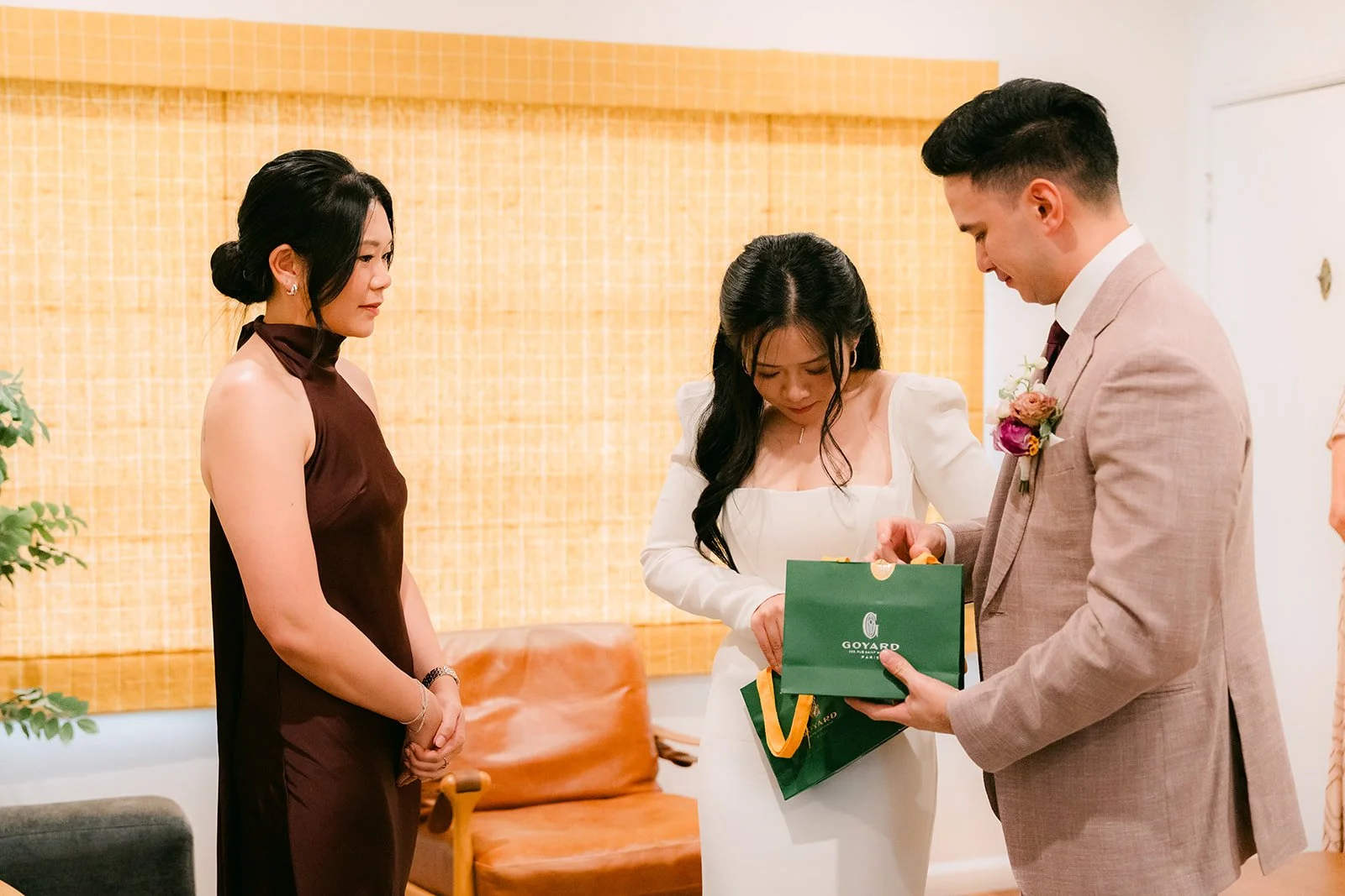 Denise's sister handing the couple a green gift box.