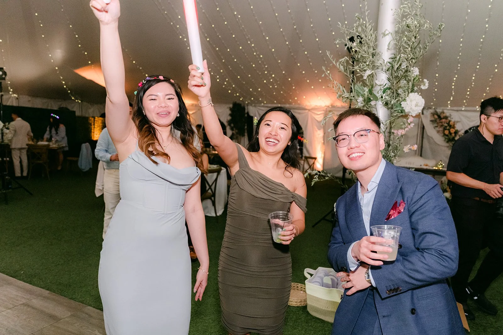 Friends dancing with glow sticks in the air