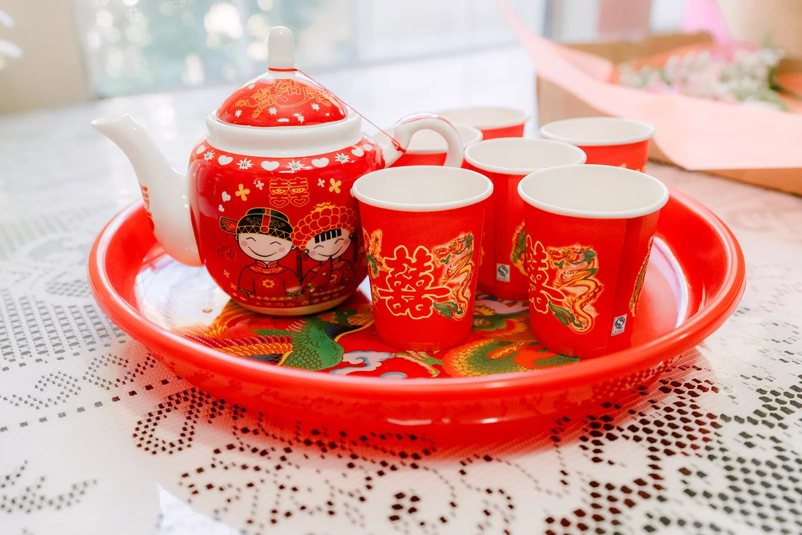 Red tea set on a lace tablecloth ready for the tea ceremony.