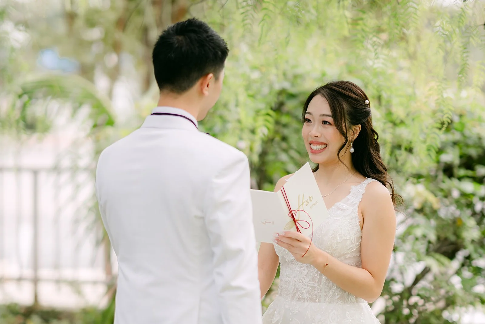 Jenny smiling as she reads her private vows to Ryan.