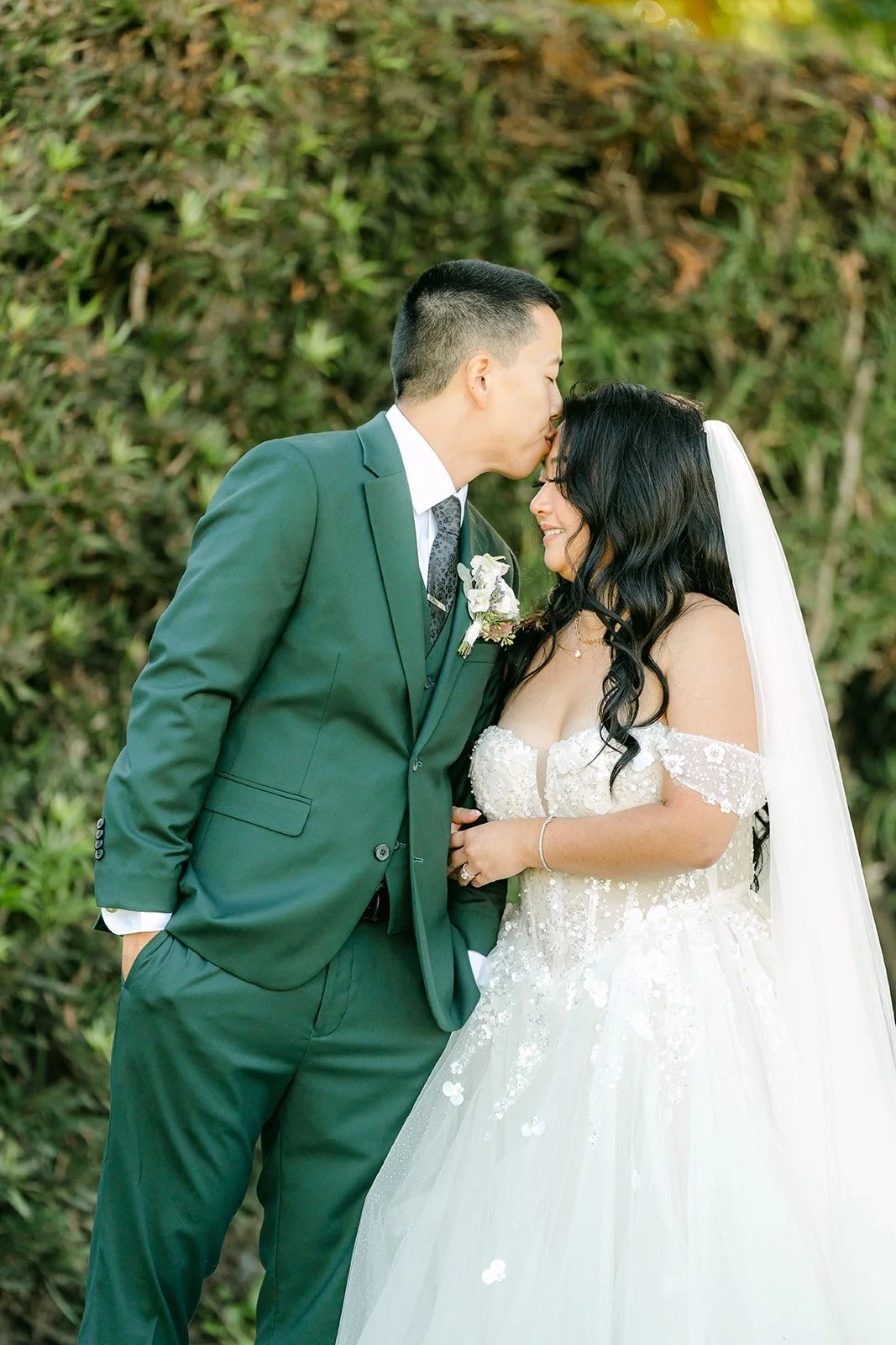 Kevin kisses Jennifer's forehead after their private vows, photographed by One and Only Production