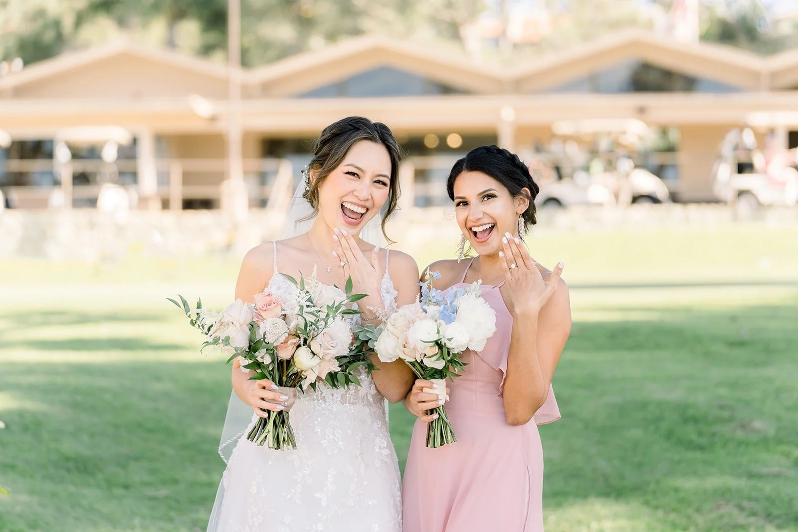 Josephine and a bridesmaid laughing with their bouquets