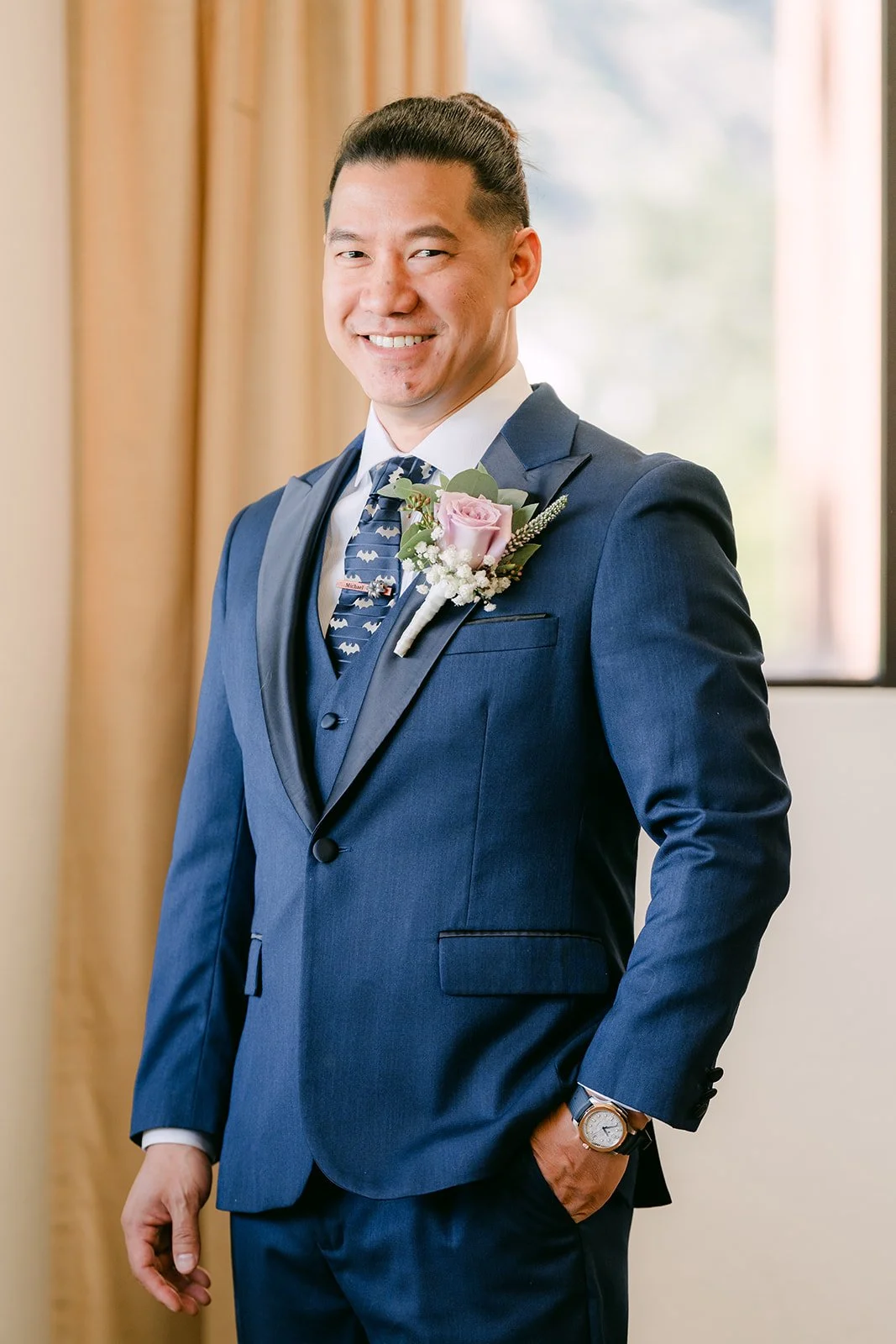 Michael smiling in his navy suit before the first look, photographed by One and Only Production.