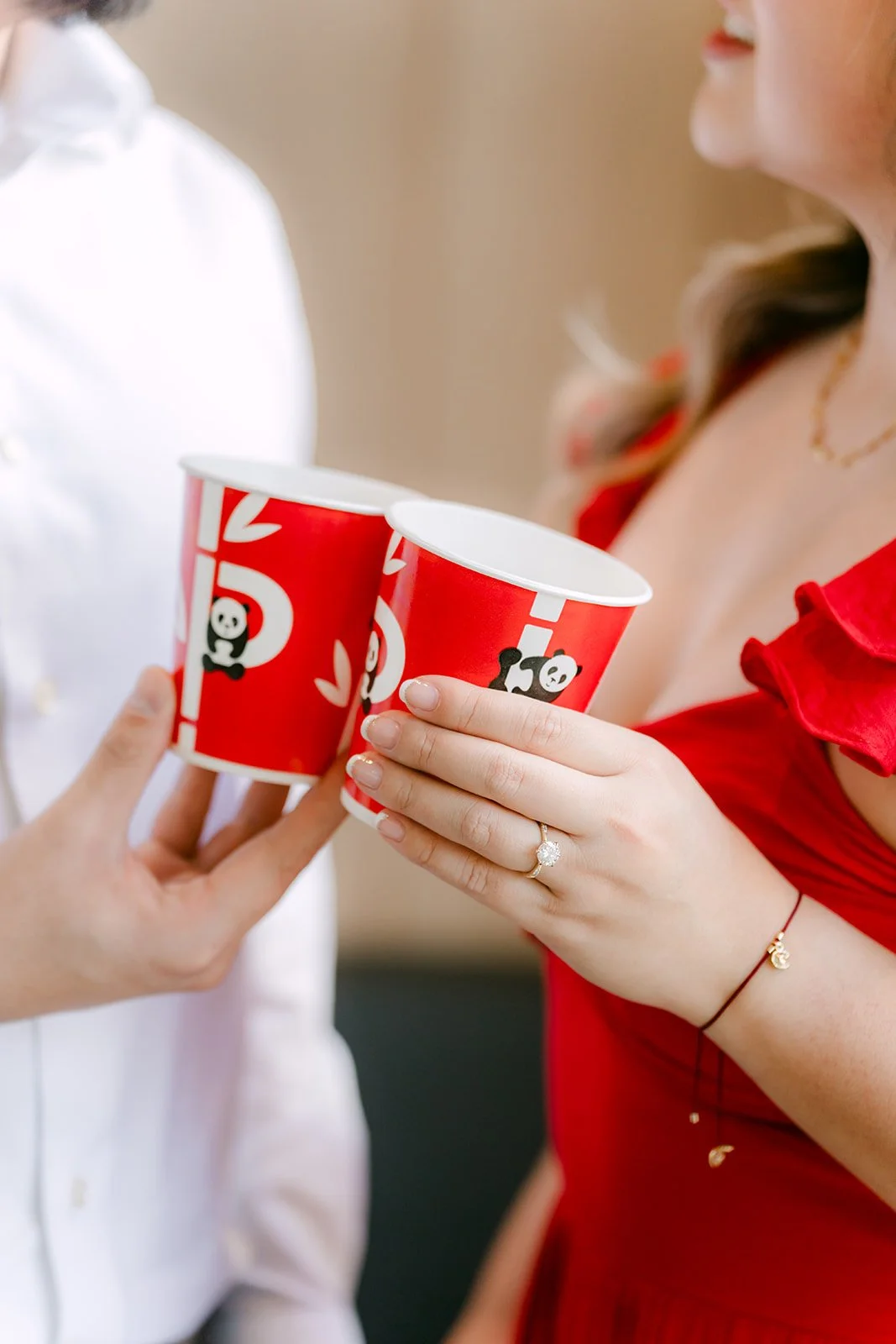 Linh and Ankush toast with Panda Express cups.