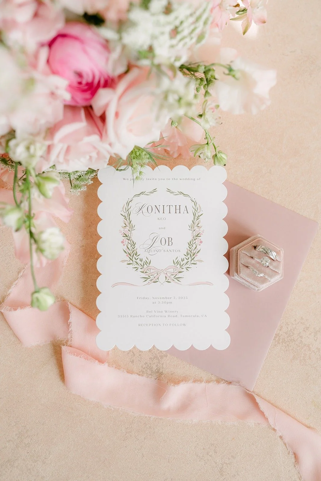 Wedding invitation with a laurel crest and pink roses