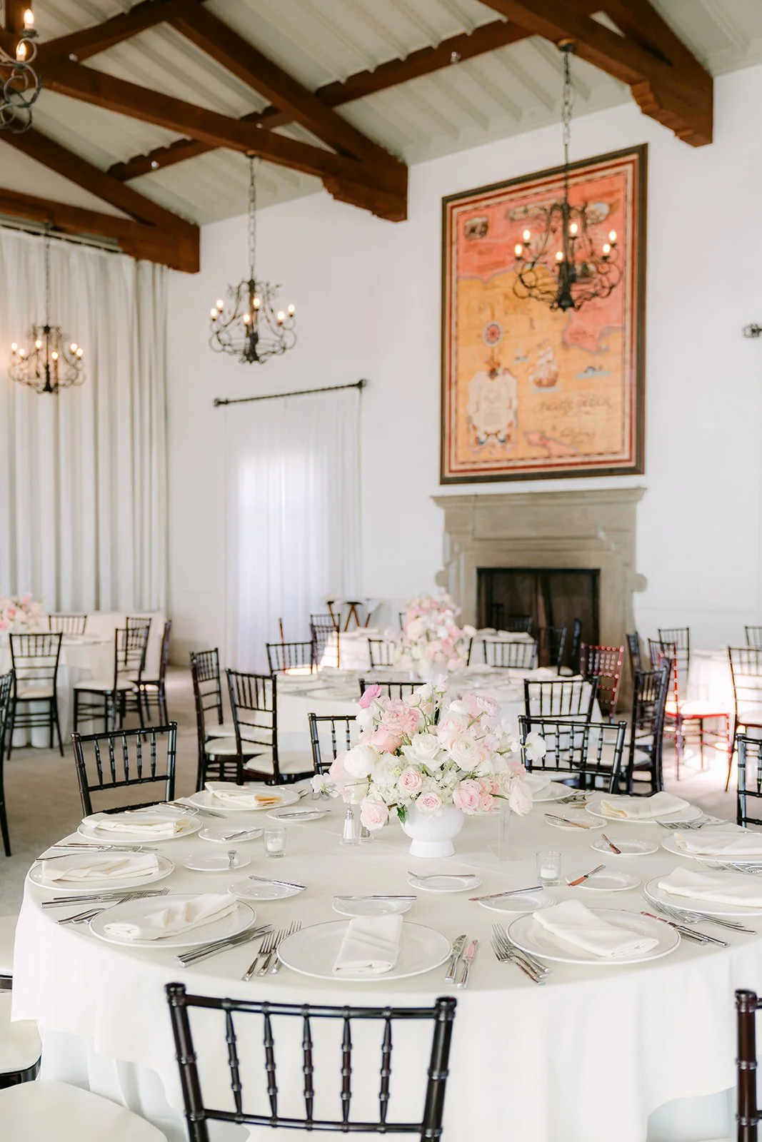 Reception room with wood beams, fireplace and set tables