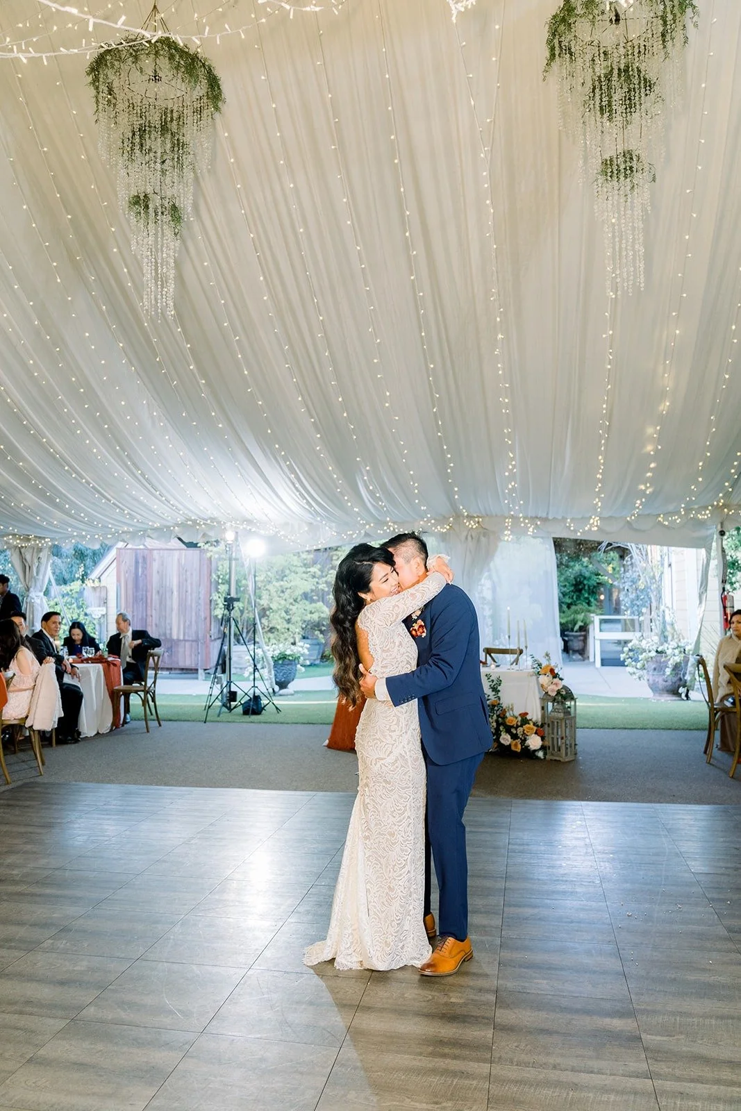 Wide view of the first dance under the draped tent