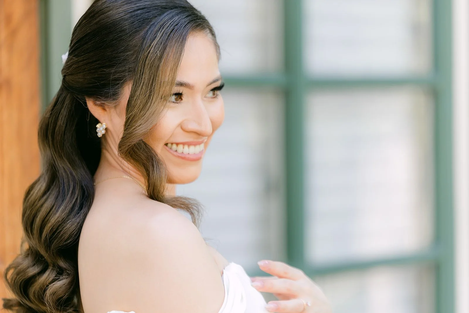 Mariana smiling in her gown by the green-trimmed window