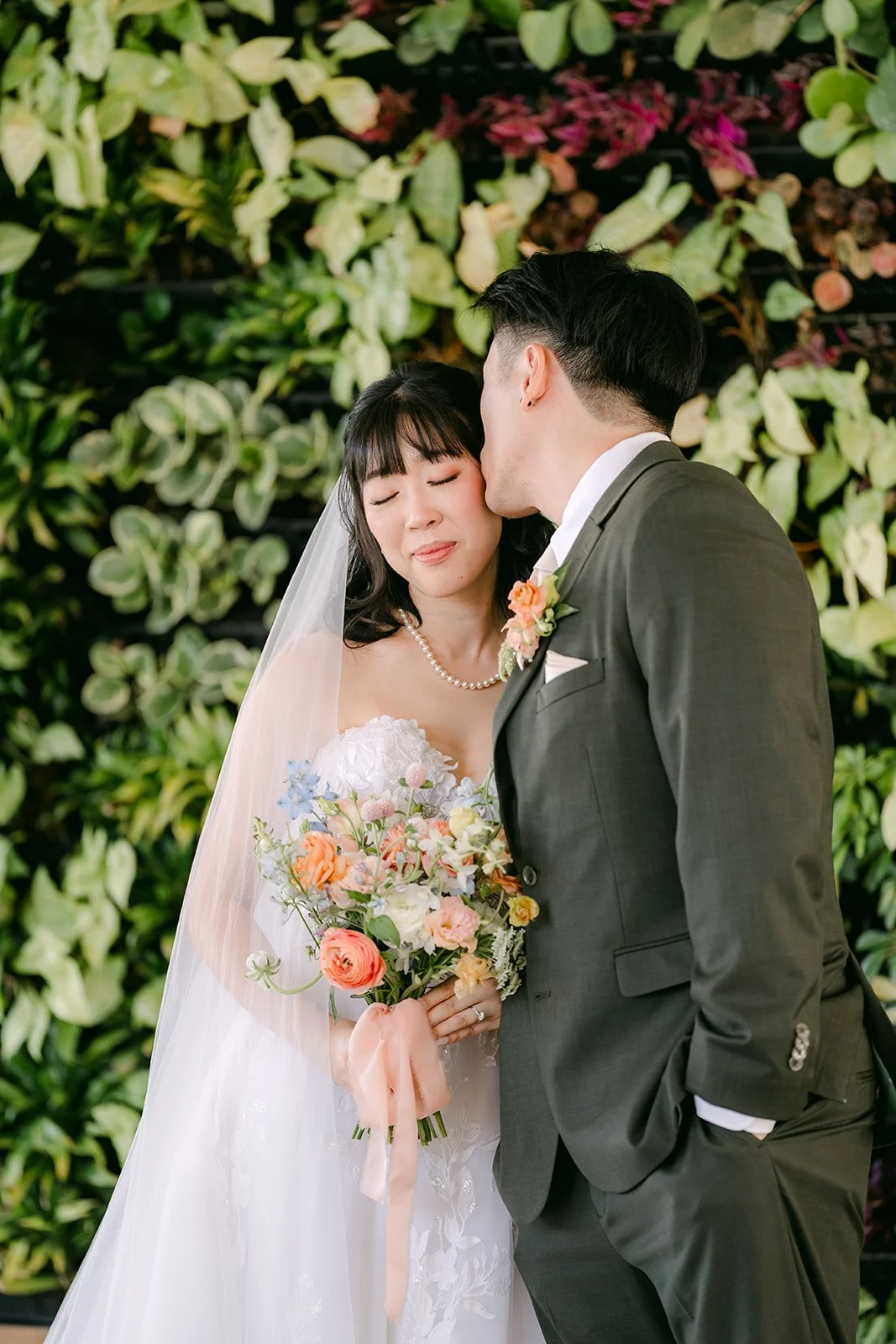 Alex kissing Vivian's temple at the living wall