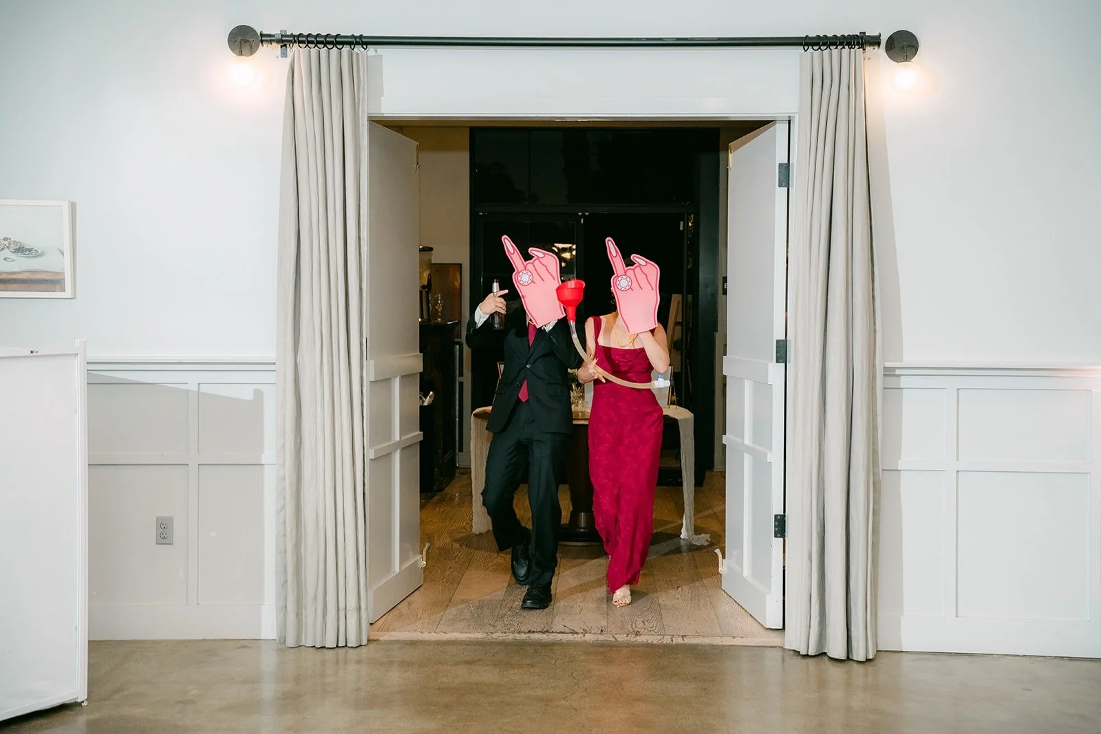 A bridal party pair entering with pink props