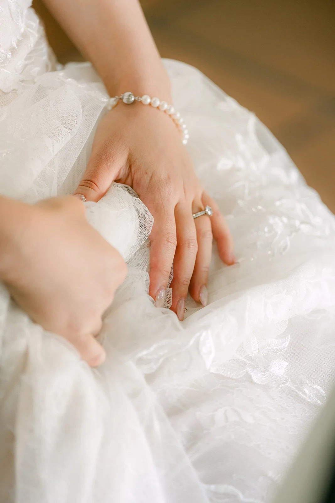 Close-up of Elaine's bracelet and the lace on her gown.