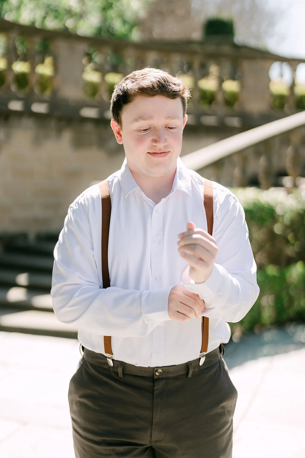 Matthew adjusting his cuff on the Greystone garden staircase.