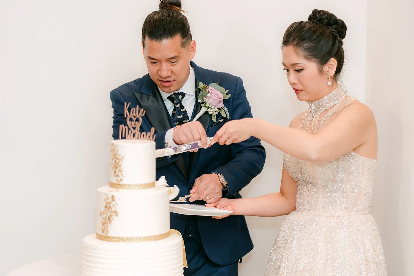 Kate and Michael feeding each other cake.