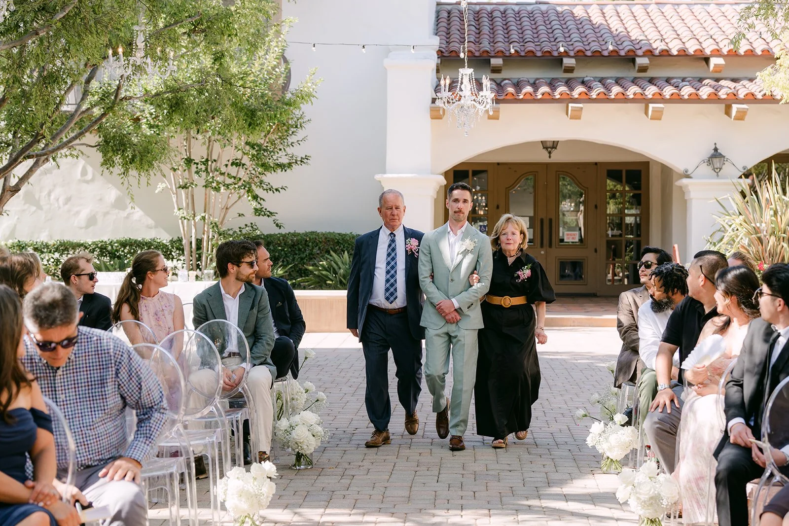 Anthony walking down the aisle with his parents