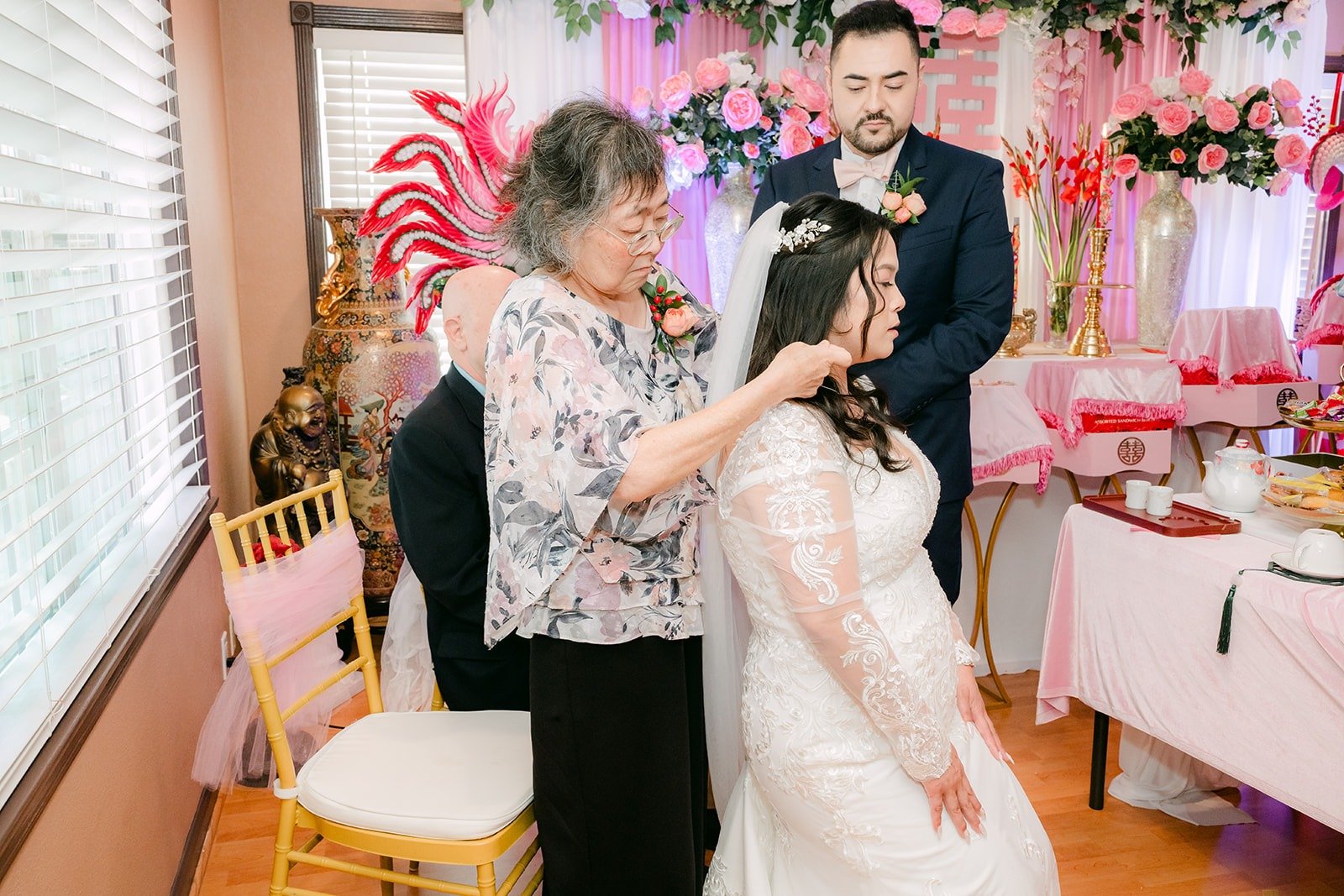 A relative placing jewelry on Amy during the tea ceremony