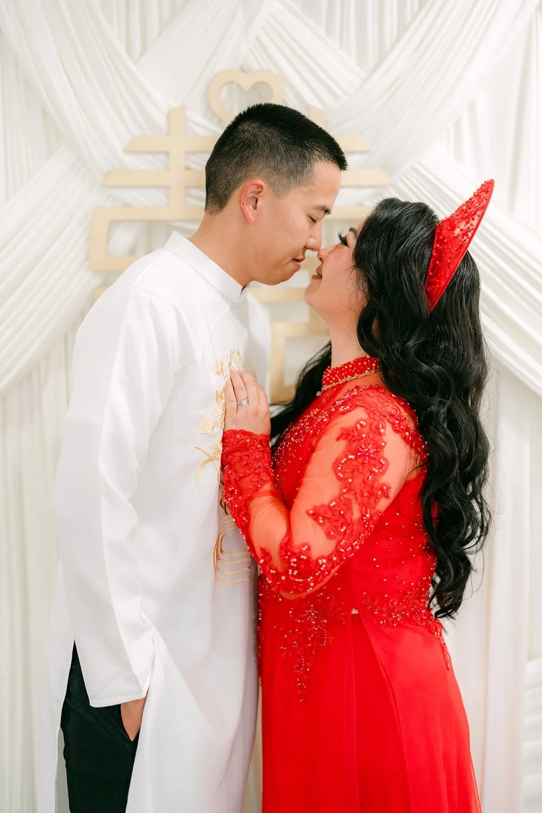 Jennifer and Kevin lean in for a kiss in their tea ceremony attire