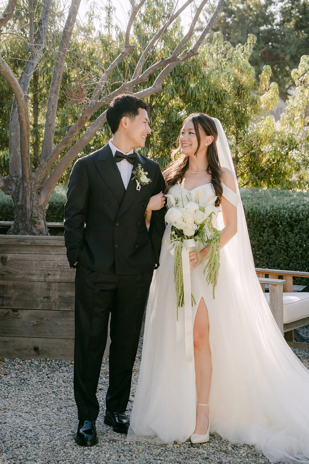 Jadee and Richard smiling among the olive trees after the first look