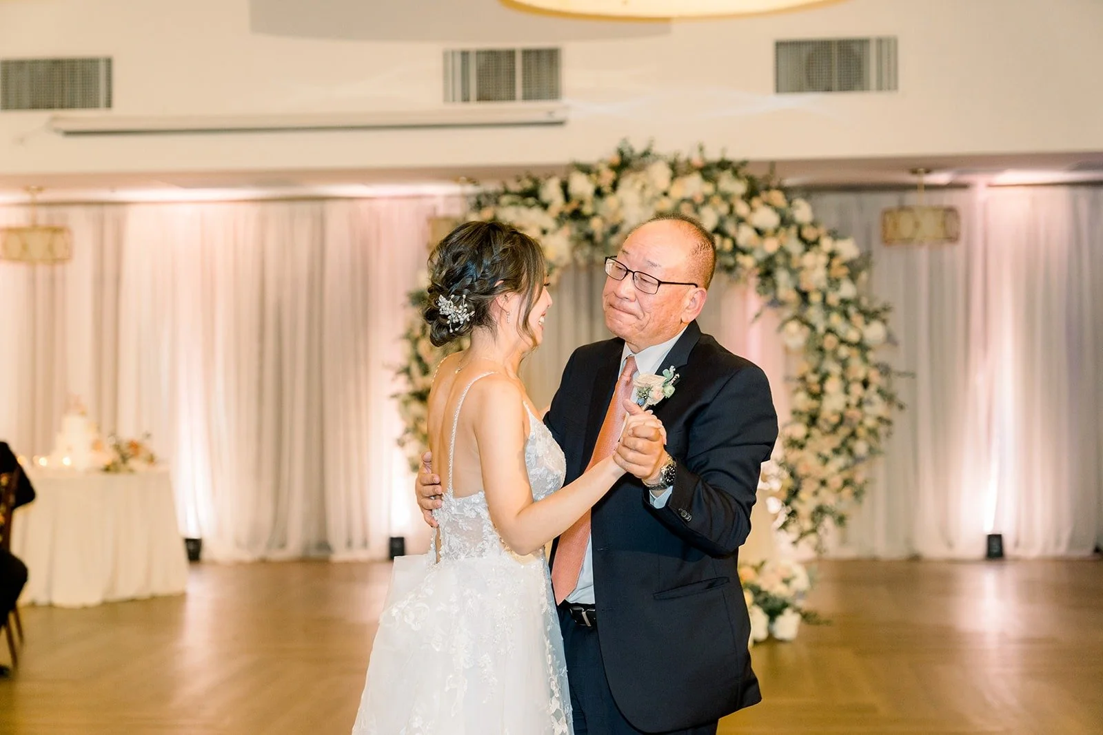 Josephine and her dad sharing a dance by the floral arch