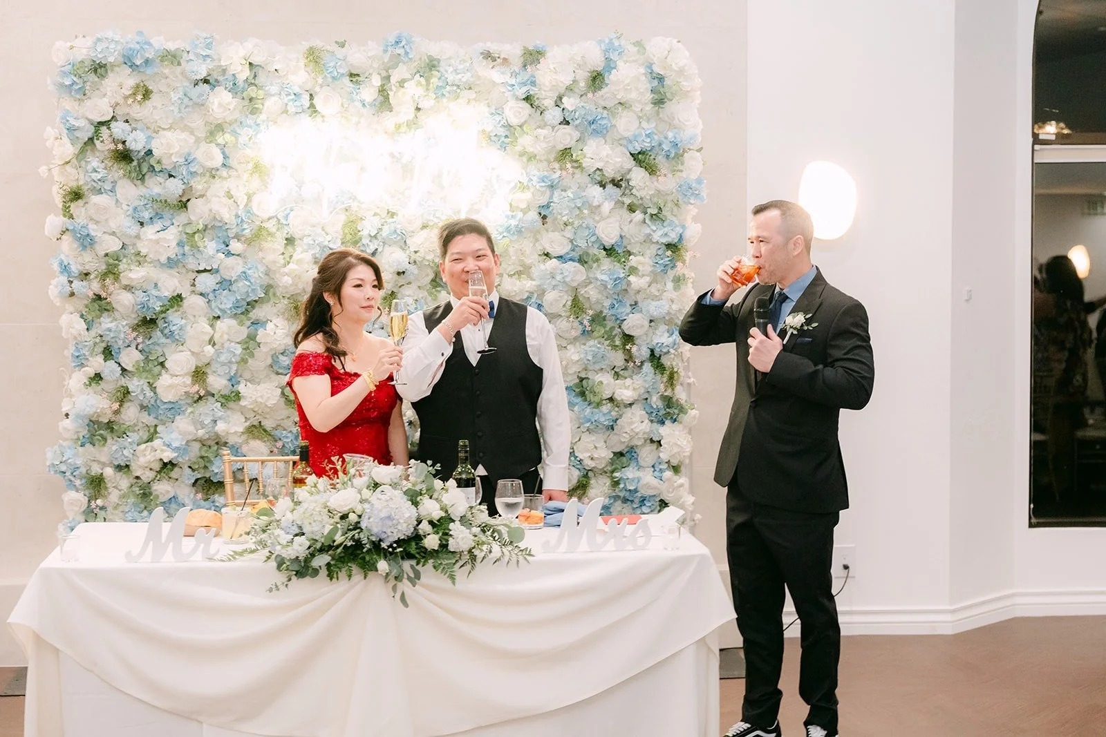 Sochi and Jay raise their glasses at the sweetheart table