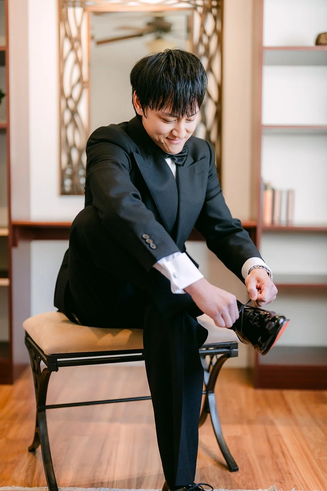 Job lacing up his dress shoes